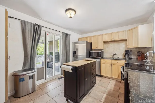 a kitchen with a stove top oven sink and cabinets