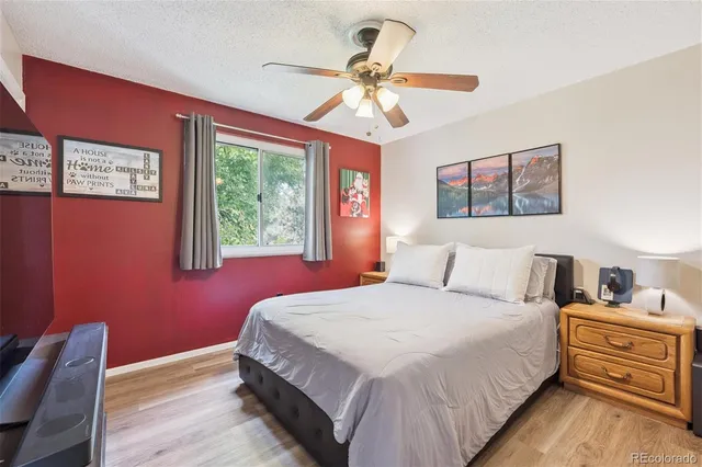 a bedroom with a bed chandelier and dresser