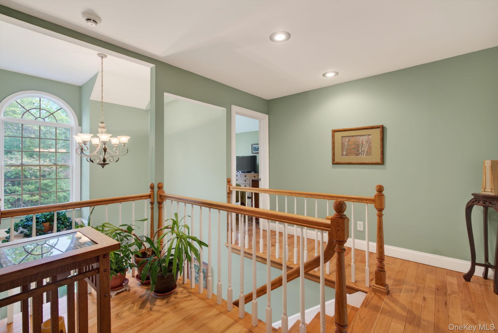 189 Bush Road Stone Ridge, NY 12484 - Photo 19 of 49 a view of a hallway with wooden floor and windows