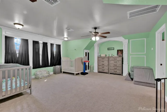 a view of a livingroom with furniture and a ceiling fan
