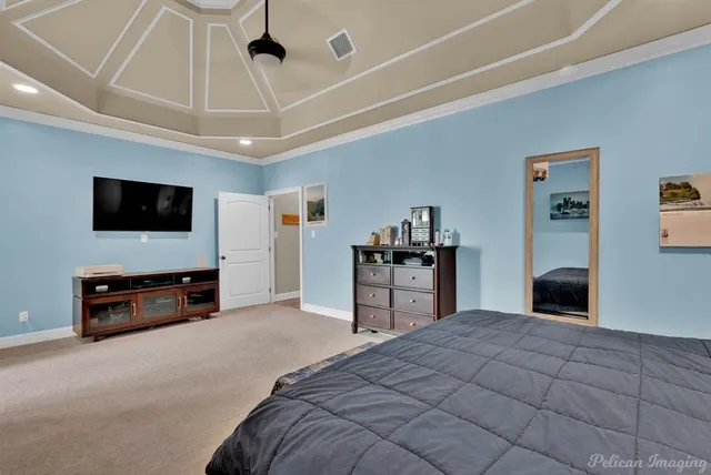 a bedroom with furniture and a flat screen tv