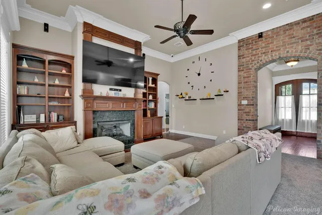 a living room with furniture ceiling fan and a fireplace
