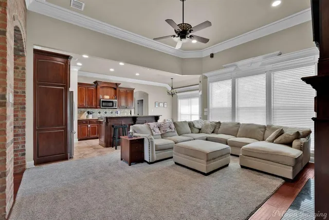 a living room with furniture and a large window
