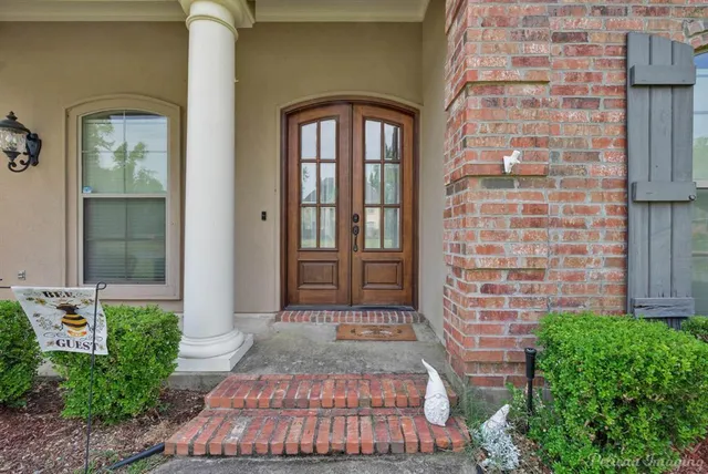a view of a house with a big yard and a garden