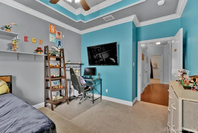 a bedroom with furniture and a flat screen tv