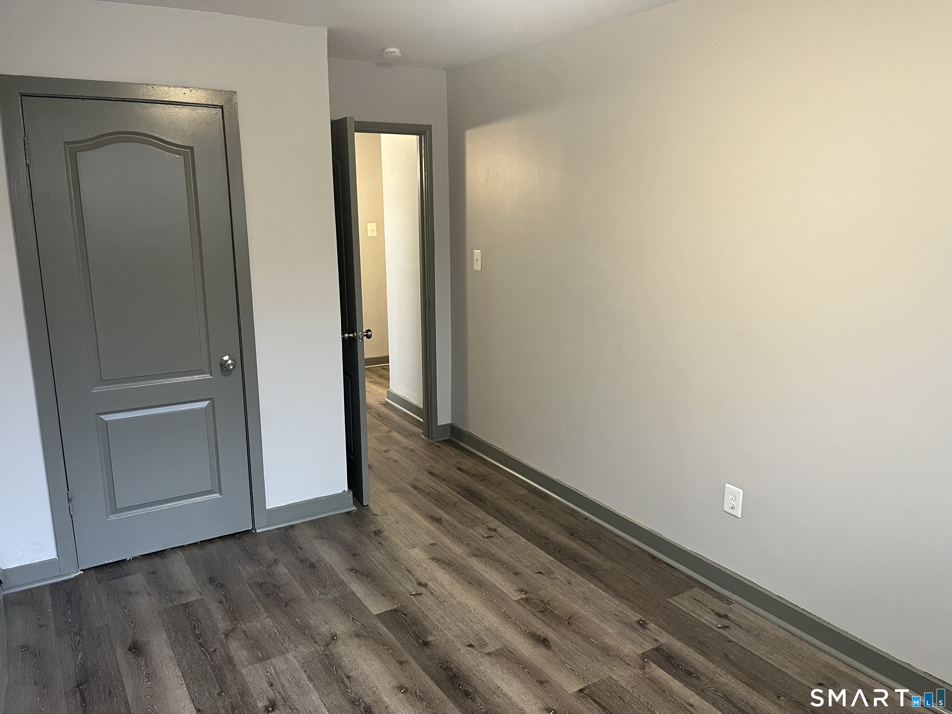 32 Cook Avenue, Unit 305 Meriden, CT 06451 - Photo 12 of 16 an empty room with wooden floor and closet