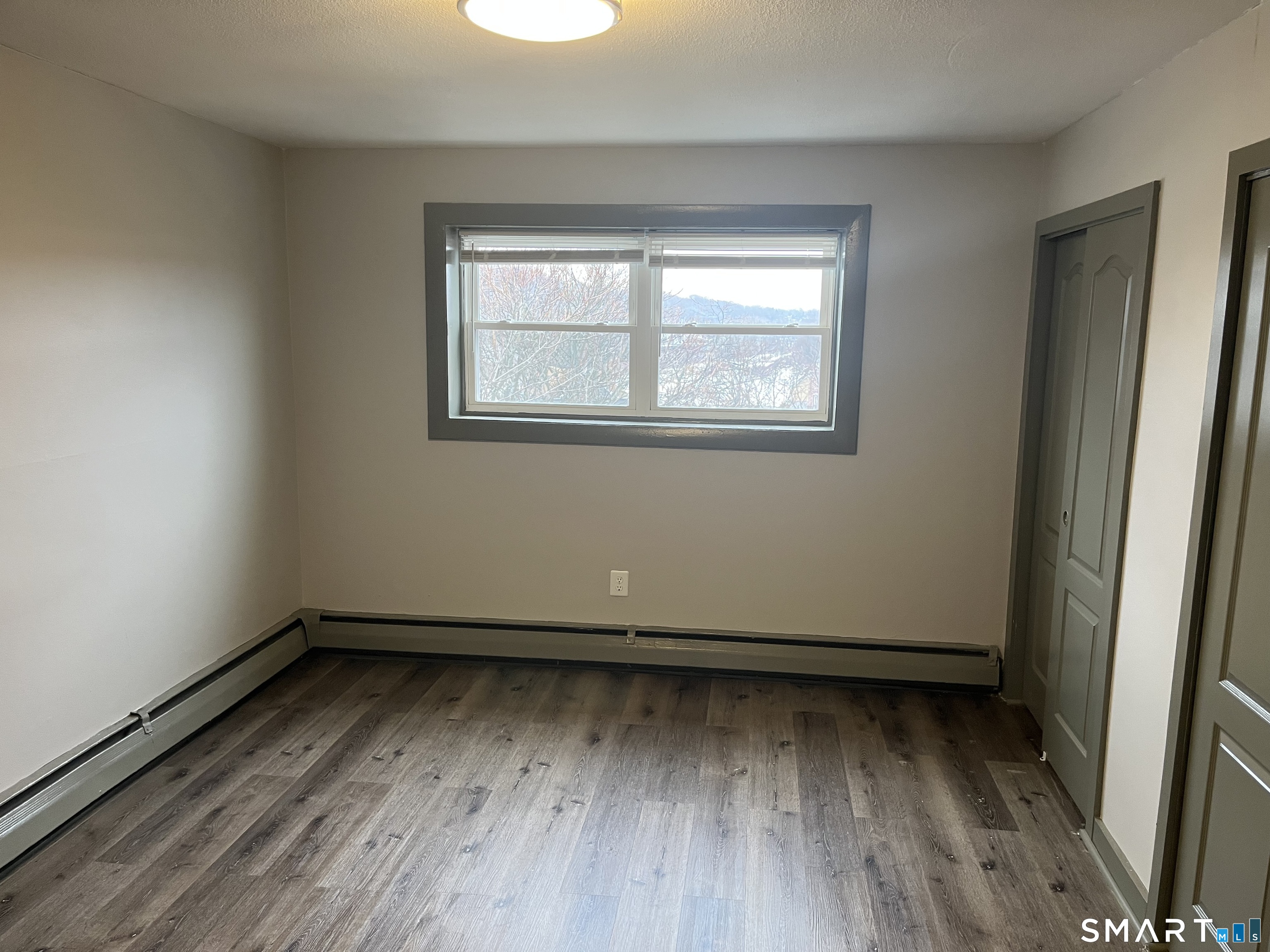 32 Cook Avenue, Unit 305 Meriden, CT 06451 - Photo 15 of 16 a view of a room with wooden floor and window