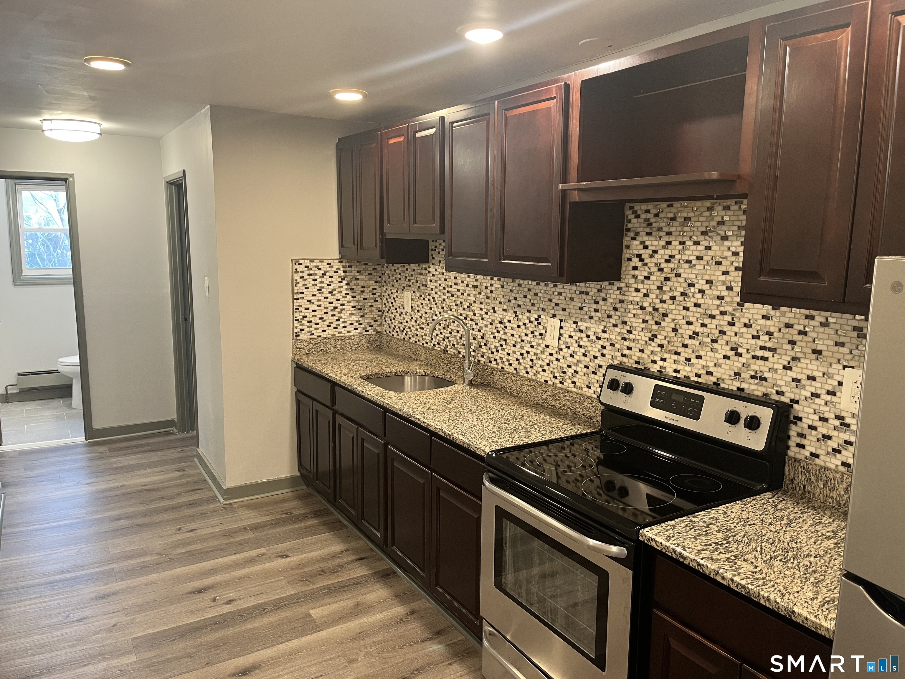 32 Cook Avenue, Unit 305 Meriden, CT 06451 - Photo 2 of 16 a kitchen with stainless steel appliances granite countertop a stove a sink and a refrigerator