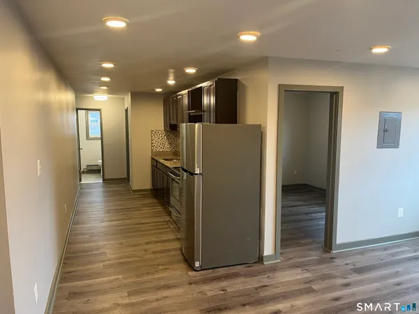 a view of a refrigerator in kitchen and wooden floor