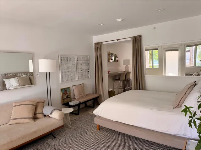 a bedroom with a bed couch and window