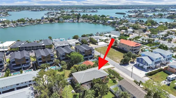 an aerial view of a houses with a lake view