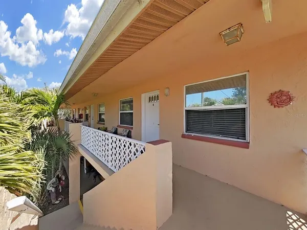 a view of backyard with deck and outdoor seating