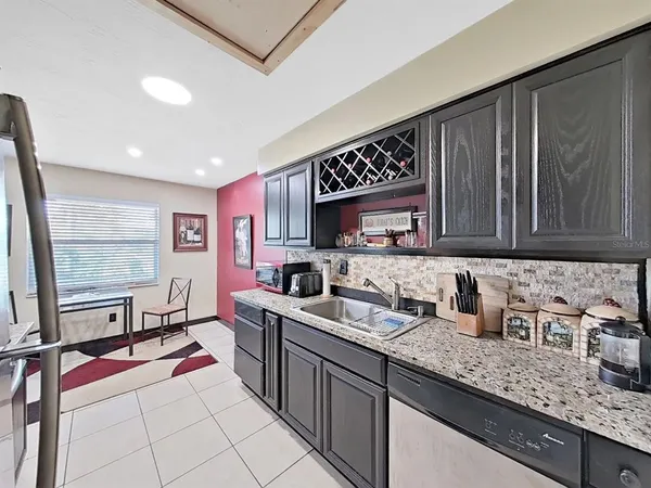 a kitchen with stainless steel appliances a sink stove and cabinets