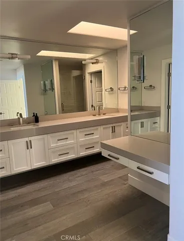 a bathroom with a double vanity sink and a mirror