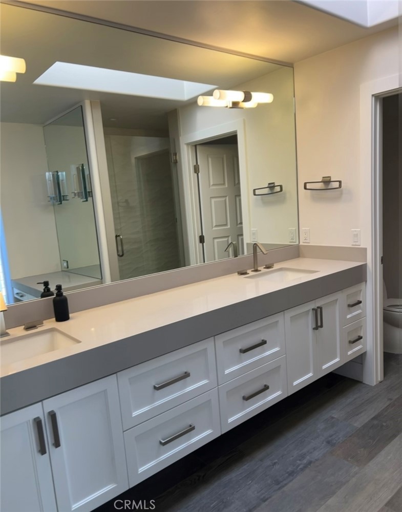 2929 Sandy Pointe, Unit 19 Del Mar, CA 92014 - Photo 14 of 17 a bathroom with a double vanity sink and a mirror