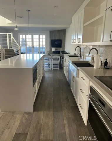 a large kitchen with stainless steel appliances granite countertop a lot of counter space