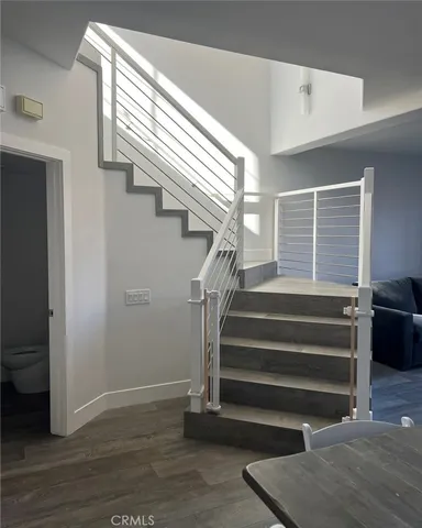 a view of entryway and hall with wooden floor