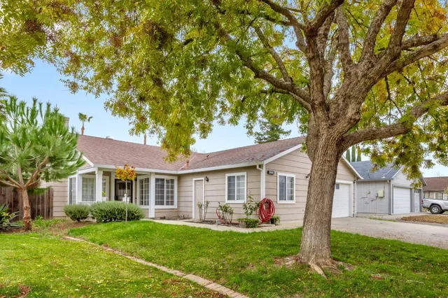 a front view of a house with a yard and porch