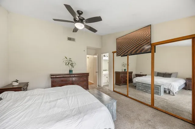 a bedroom with a bed and a large window