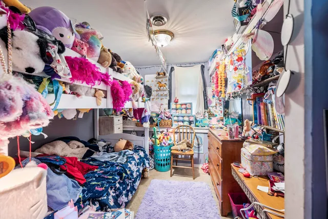 a bedroom with furniture and a window