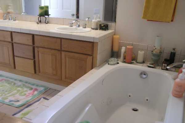 1534 Pe'e Road Koloa, HI 96756 - Photo 10 of 14 a en suite bathroom with a double vanity sink and a mirror