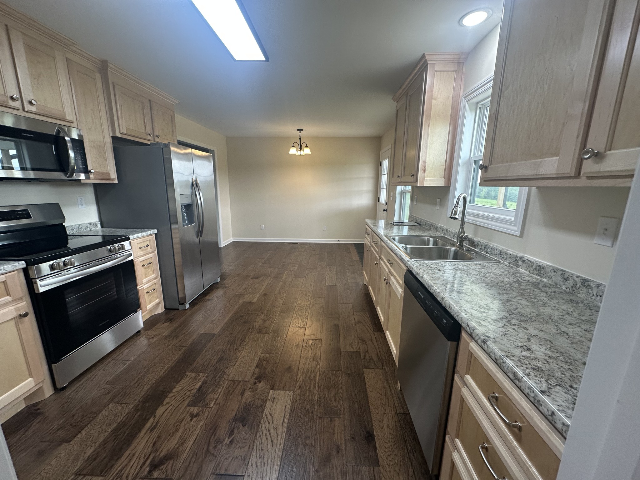 1654 Linville Road Lawrenceburg, TN 38464 - Photo 21 of 33 a kitchen with stainless steel appliances granite countertop a sink stove and refrigerator
