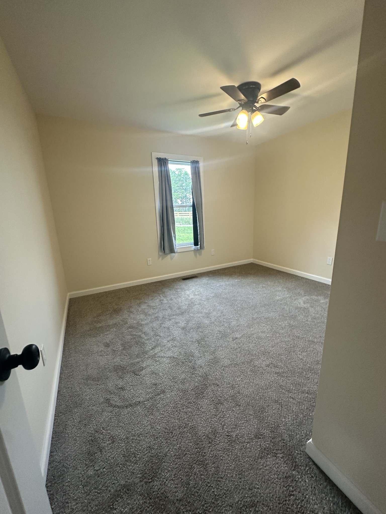 1654 Linville Road Lawrenceburg, TN 38464 - Photo 22 of 33 an empty room with windows and fan