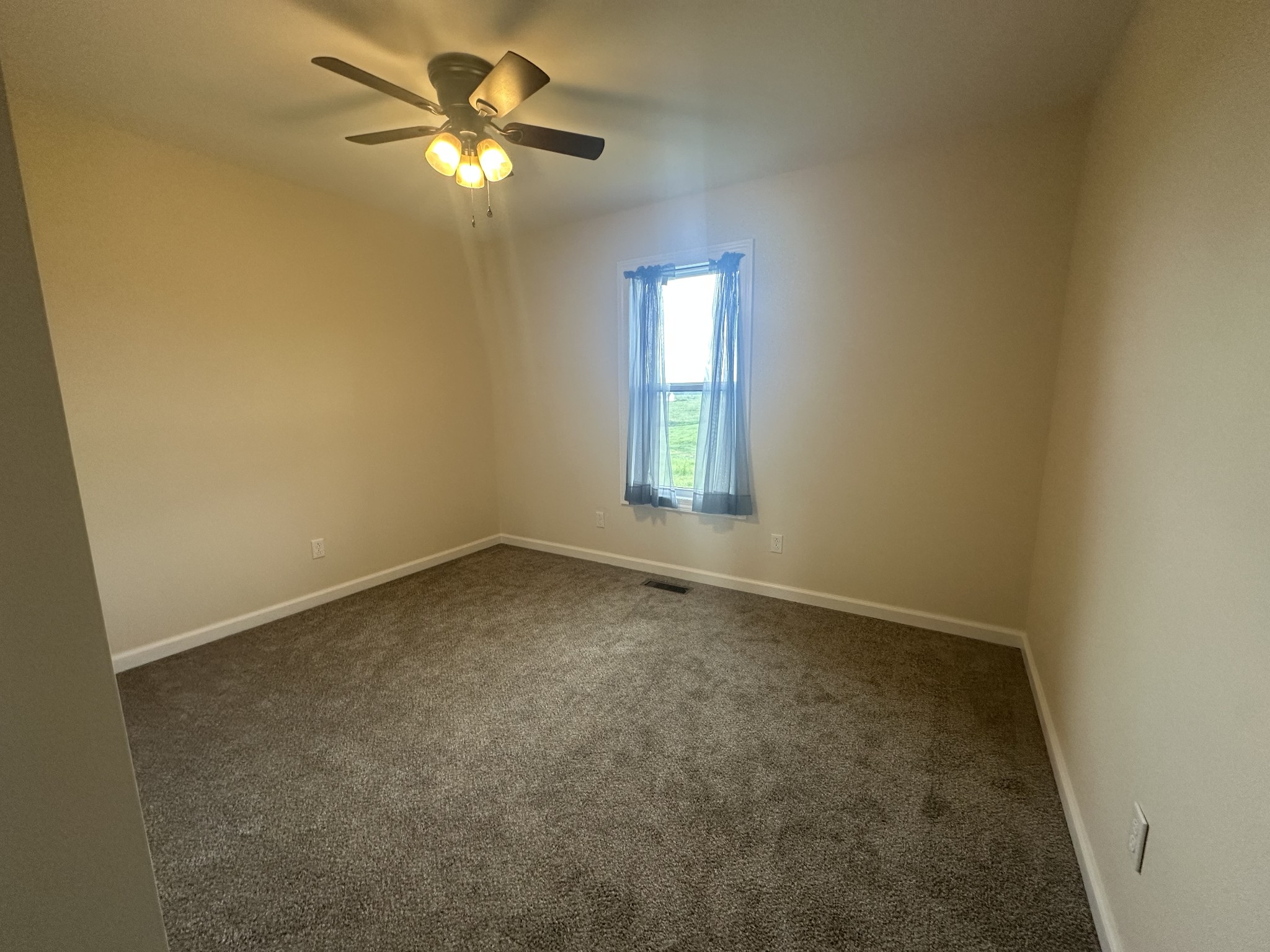 1654 Linville Road Lawrenceburg, TN 38464 - Photo 23 of 33 an empty room with a window and a chandelier fan