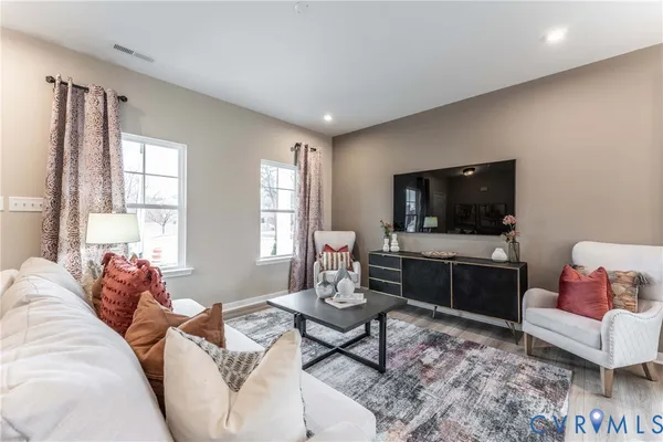 a living room with furniture and a flat screen tv