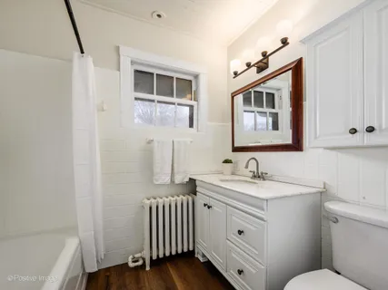 a bathroom with a sink toilet and mirror