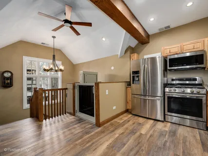 a kitchen with stainless steel appliances granite countertop a refrigerator and a stove top oven