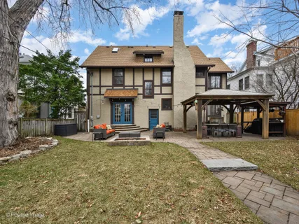 a view of a house with a patio and a yard