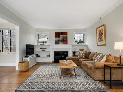 a living room with furniture a rug and a flat screen tv