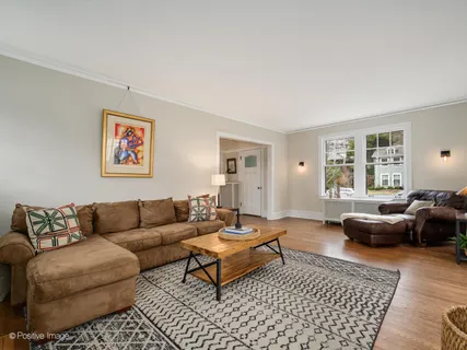 a living room with furniture a rug a window and a couch