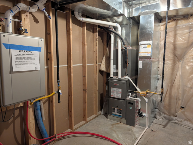 171 South Mustang Road East Grantsville, UT 84029 - Photo 20 of 41 Tankless water heater and Lennox furnace system with exposed ductwork and plumbing