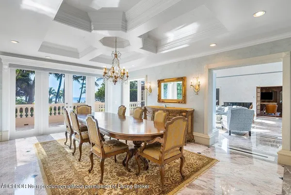 a dining room with furniture a chandelier and wooden floor