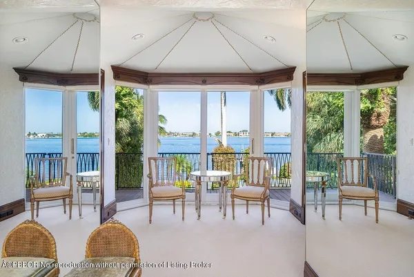 a living room with furniture and a floor to ceiling window