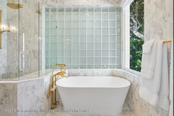 a bathroom with a bathtub and shower