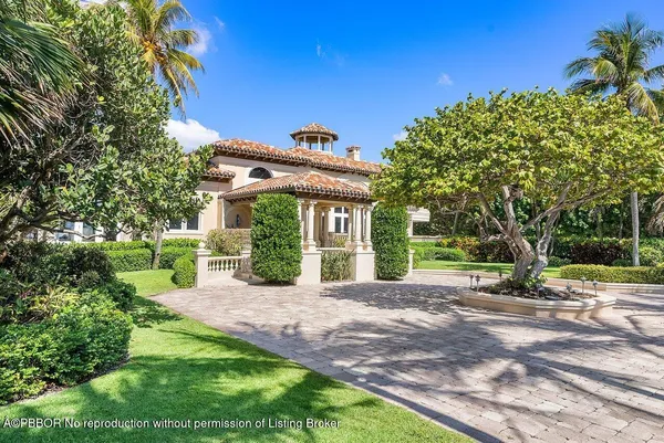 a view of a house with a big yard and potted plants