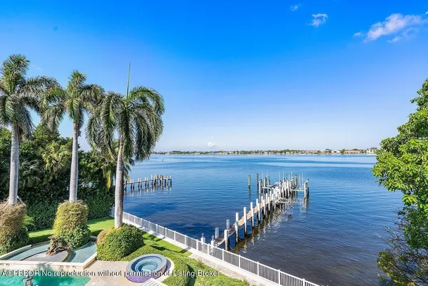 a view of a house with pool and chairs