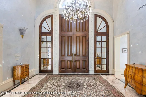 a view of front door with furniture and a window