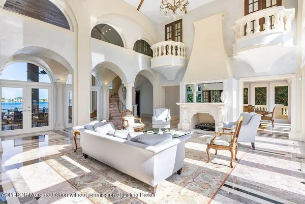 a living room with fireplace furniture and a rug