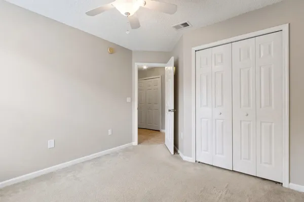 an empty room with a ceiling fan