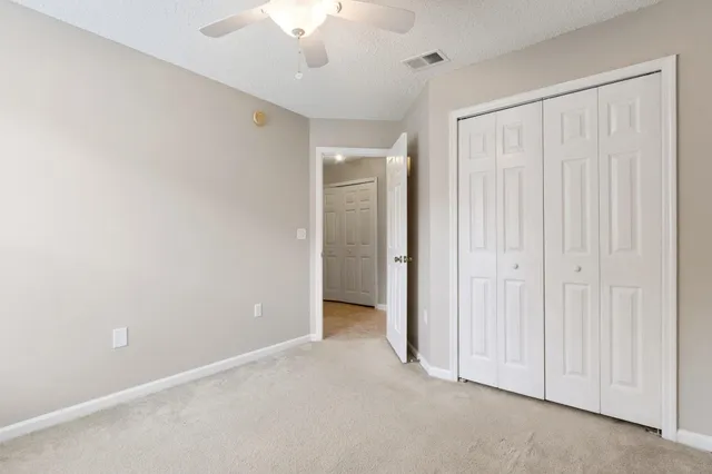 an empty room with a ceiling fan