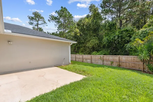 a backyard of a house with lots of green space