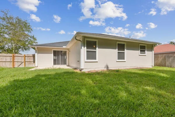 a view of a house with a backyard