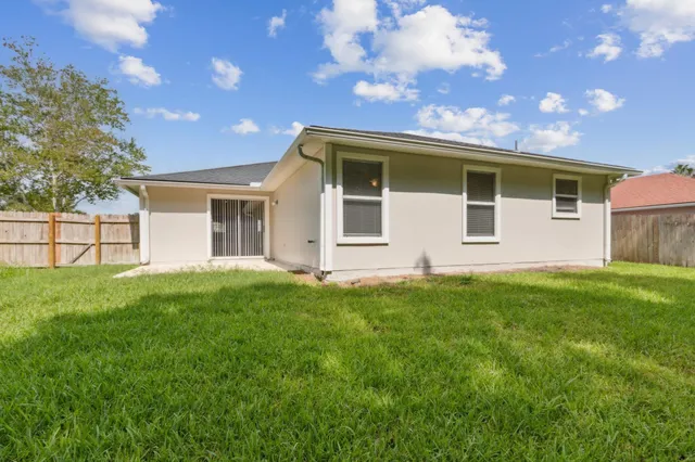 a view of a house with a backyard
