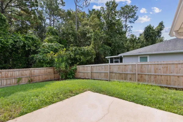 a view of a house with a yard and sitting area