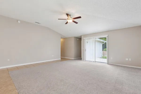 a view of an empty room with a ceiling fan