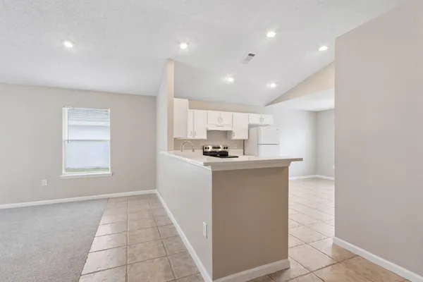 a living room with kitchen island furniture and a window